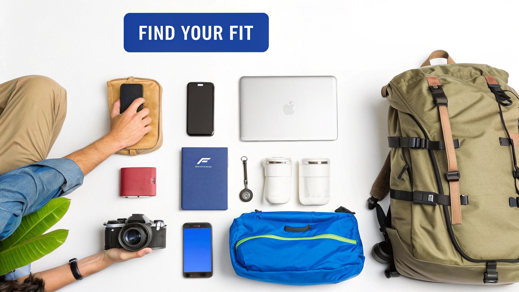 Flat lay of travel essentials: a person's hands organizing a backpack, laptop, camera, and phones.